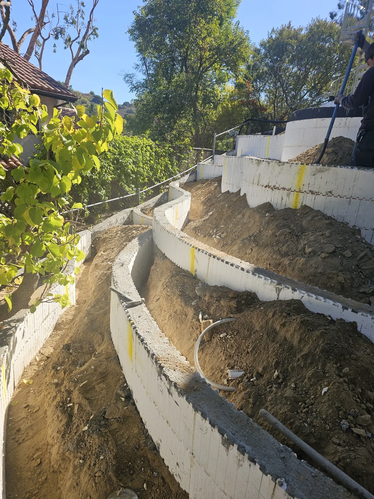BAC ICF construction work in progress on a hillside jobsite